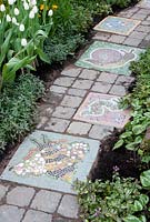 Animal mosaics in cobble sett path in the 'A Year in the Life of DreamScheme' garden, RHS Tatton Flower Show 2012