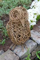 Woven willow bird sculpture in 'A Year in the Life of DreamScheme' garden, RHS Tatton Flower Show 2012