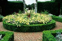 The brick Garden - Phoenix canariensis, Agyrantheum 'Jamaica Primrose', Verbena 'La France', Canna 'Durban' - Kingston Mauward Garden, near Dorchester, Dorset, UK