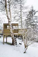Children's treehouse in the snow in winter