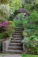 Steps leading up through arch from main garden to vegetable garden