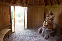 Sculpture of Madonna and child in the wooden chapel at Greencombe Gardens, Somerset