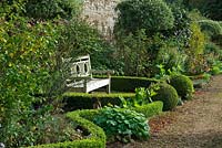 Buxus hedge with wooden bench
