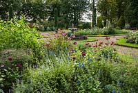 Fountain garden with beds full of salvias, zinnias, calendulas and other late season flowering plants