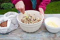 Step by step for creating hanging bird feeders out of teacups and yoghurt pots - stirring mixture 