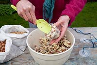 Step by step for creating hanging birdfeeders out of teacups and yoghurt pots - adding mixture