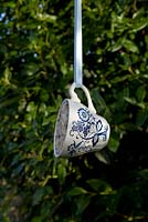 Step by step for creating hanging birdfeeders out of teacups