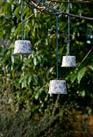 Step by step for creating hanging birdfeeders out of teacups and yoghurt pots
