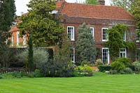 Large country house, lawn, spring border