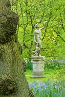 Stone statue in country garden, spring 