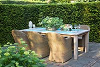 Secluded seating area surrounded by Taxus hedge
