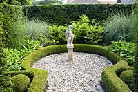 Small formal garden with statue as focal point