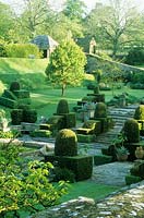 View across Fountain Court. Clipped mounds of Yew.  - Mapperton Garden, Beaminster, Dorset, UK. May. 