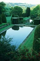 View across pool in Daniell's Garden.  Mapperton Garden, Beaminster, Dorset, UK. May.