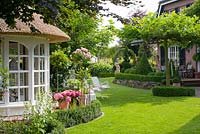 Summerhouse and lawn, clipped box hedges 