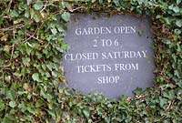Garden Open sign painted on a wooden board surrounded by Herdera - Wyken Hall, Suffolk