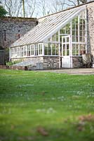 Lean-to glasshouse on the outside wall of the walled garden at Wretham Lodge, Norfolk