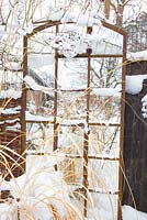 Metal gate covered in snow