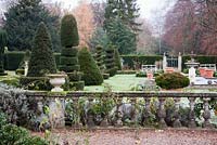 Formal terraced patio and balustrade overlooking formal Italianate Topiary Garden - The Old Rectory, Surrey