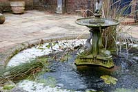Italian themed patio area with central fountain and pond - The Old Rectory, Surrey