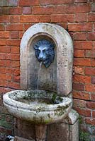 Italian style drinking fountain on wall - The Old Rectory, Surrey