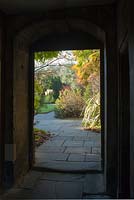 View through doorway to garden with york stone paving - Peterhouse College, Cambridge