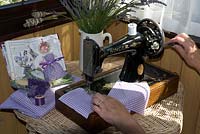 Woman using sewing machine to make lavender sachets