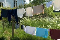 Washing drying on line and fence in garden of country cottage