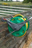 Garden hose on reel, fixed to vertical fence for ease of use - Bays Farm NGS, Forward Green, Suffolk
