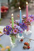 Candles holders decorated with Asters and berries