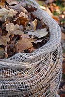 A biodegradable jute leaf sack full of autumn leaves