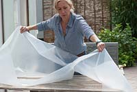 Making a decorative path - laying sheet of plastic over garden table