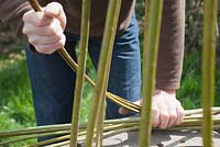 Weaver Dominic Parrette twisting the pliable willow between the uprights - Sussex Willow 