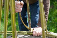 Weaver Dominic Parrette twisting the pliable willow between the uprights - Sussex Willow 
