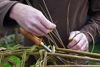 Weaver Dominic Parrette making a woven willow plant support - Sussex Willow 
