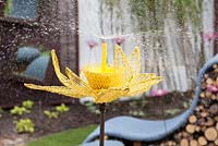 Water sprinkler made from chicken wire and shaped like a giant flower