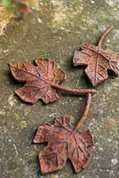 Rusty metal leaves on table - Ulla Molin