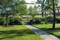 Landscaped gardens with herbaceous borders and ornamental trees, Aurora, NY
