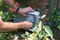 Fixing mains socket in weather proof box in border for 12 volt transformer connection