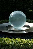 Glass ball fountain with a low Buxus hedge in June - Richard Ayres' Garden