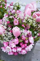 Japanese cherry blossom, pink tulips and Anthriscus sylvestris in metal bucket
