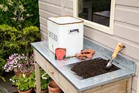 Step by Step -  Planting Carrot 'Sugarsnax' in a bread bin - tools and equipment on potting bench 