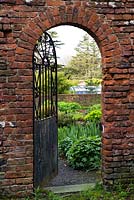 Old metal gateway leading to the perennial beds and orchard of Cally Gardens Nursery