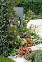 Contemporary garden with granite paving and stainless steel art panels - 'Solar Chic' Show Garden, Silver Award, Malvern Spring Show 2013