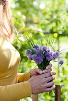 Woman with bouquet of recently picked chives