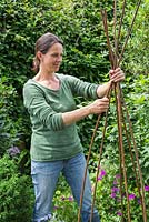 Step by step -  Making a decoration from small terracotta pots to hang inside hazel wigwam - making the wigwam
