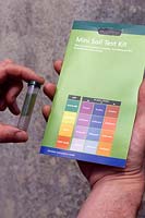 Using a soil testing kit which is showing alkaline soil type