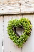 Step by Step - Turf heart hanging on wooden door