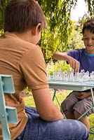 Children playing chess in garden setting