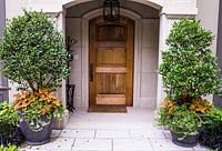 Entrance to house with containers planted with Coleus, Bacopa, Impatiens and Camelia 'Yuletide' 
